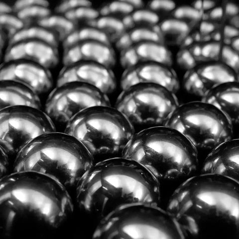 The Essential Role of Bearings in Cutting Down Friction - close-up of metal bearings arranged in a pattern.