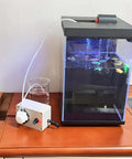 12V Adjustable Peristaltic Dosing Pump Liquid Metering Pump connected to aquarium, shown with adapter and tubing, model EK1960