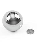 Get Top Shelf Performance With These Bad Ass High Precision G Twenty Five Grade Chrome Steel Ball Bearings Measuring One Point Five Inch In Diameter Hot Forged For Ultimate Durability And Reliability Perfect For Heavy Duty Applications next to a quarter for size comparison.