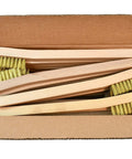 Open box showing 24 Pack Brass Wire Brush Tooth Brushes with wooden handles for rust removal and metal prep.