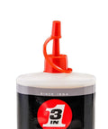 Close-up of the top of a 3-IN-ONE Multi-Purpose Oil, 8 OZ bottle, showing red twist spout and part of the black and white label.