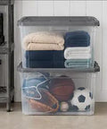 Tackle The Mess Fast With This Beast Mode 108 Quart Stackable Storage Bin Packing. Clear bins holding blankets and sports equipment.