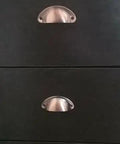 Upgrade Your Home With Hella Sturdy Iron Cup Pulls Featuring A Classic Vintage Shell Shape And Smooth Red Copper Brushed Finish Perfect For Dressers And Kitchen Drawers Ten Piece Kit on black drawers.