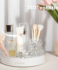 360 Degree Rotating Makeup Organizer With Perfume Tray And Skincare Holder, displaying cosmetics and brushes on a vanity.
