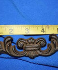 Straight Up Classic Victorian Swirl Cast Iron Drawer Pulls Set Of 20 For Furniture And Cabinet Restoration 6 1/4 Inch close-up of brown drawer pull with ruler for size reference