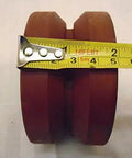 Bulletproof Four Inch Two Inch V Groove Caster Wheel With Seven Eighths Stem Crafted From Rugged Ductile Steel And Rollin Smooth On Heavy Duty Bearings For A Rock Solid One Five Zero Zero Pound Load Rating In Classic Burgundy showing measurement with tape.