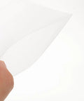 Image of a hand holding a thin white EPE foam sheet from the 100 Piece EPE Foam Packing Sheets For Shipping And Storage.