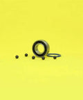 Heavy Duty Hybrid Ceramic Bearings 8x16x5mm Abec-1 with Si3N4 balls and steel races on yellow background.
