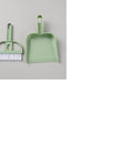 Green Mini Broom And Dustpan Set With Handle on grey background, ideal for small pet cages, desks, tight spaces, and car interiors.