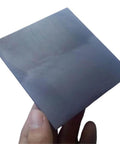 Hand holding a Five Pack Graphite Sheet Plates Pro Grade 150 By 100 By 4 Mm For 3D Print Crucibles Tool Carbon Graphite Cake Heat Resistant Plate