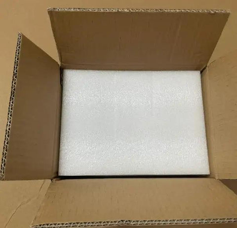 Open cardboard box with white foam insert for cushioning, ideal for shipping Badass Four Way Brass Solenoid Valve For Smooth Air Ride Suspension Control.