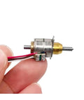 Hand holding a 5V 6V Precision Stepper Motor Starter Kit with Telescopic Linear Screw Shaft, showing the 10mm actuator and connections.