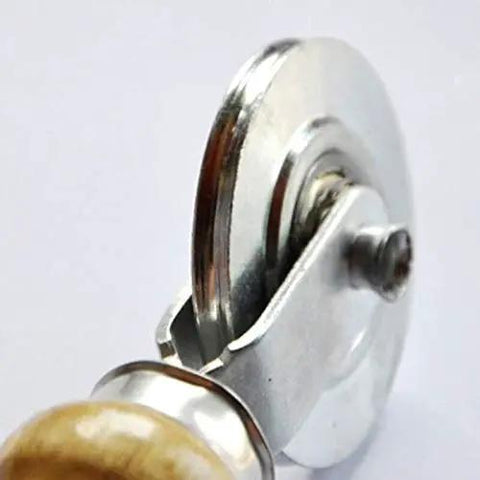 Close-up of a double head pressure wheel on the Badass Window Roller With Wooden Handle For Screen Window Seals and Rubber Strips.
