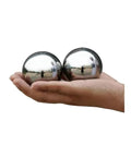 Precision Chrome Steel Baoding Balls Two Inch Hand Exercisers held in hand, sleek shiny surface, used for grip strength training.