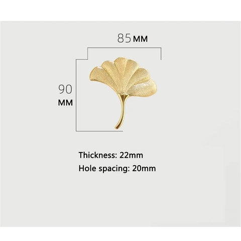 Slick Brass Cabinet Handle With Fresh Modern Nordic Vibe, leaf shape, 85mm x 90mm, 20mm hole spacing.