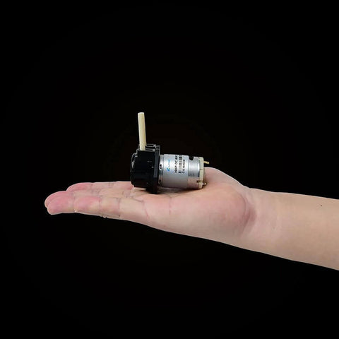 Black NKP small peristaltic pump 12V DC long service life liquid dosing pump for aquarium DIY lab analytical 2mm ID x 4mm OD with BPT tube in hand