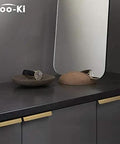 Top Shelf Pure Brass Finger Pulls With Brushed Matte Finish Hella Slim Modern Cabinet Handles Five Inch Center To Center Six Pack Rock Solid Hardware For A Slick Home Refresh on dark cabinet surface.