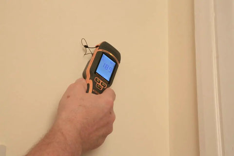 Person using SurveyMaster Dual Function Moisture Meter With Pin And Non Invasive Modes Reads Wood Drywall Concrete And Fiberglass Boat Hulls