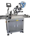 Compact Desktop Automatic Bottle Labeling Machine Delivers Kickass Accuracy For High Production Packaging Lines with grey cabinet and adjustable label applicator.