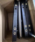 Heavy Duty Hidden Access Panel With Concealed Door Hinge Kit For Tile And Stone, black metal parts in a cardboard box.