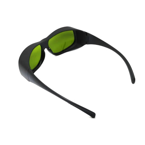 Top Shelf Tough Infrared Laser Safety Glasses Featuring Heavy Duty OD Five Plus And OD Seven Plus Shielding For ND YAG And Diode Lasers Spanning 720 To 1100 Nm Wavelengths Crisp Clear Vision, black frame with green lenses from the side.