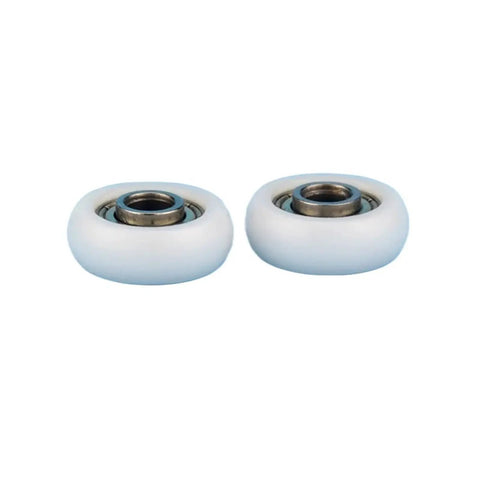 Premium Low Drag Nylon Pulley Wheels Featuring Precision Ball Bearings For Buttery Smooth Linear Motion And Aluminum Profiles Zero Friction Glide Heavy Duty Track Rollers, close-up of two white nylon wheels.