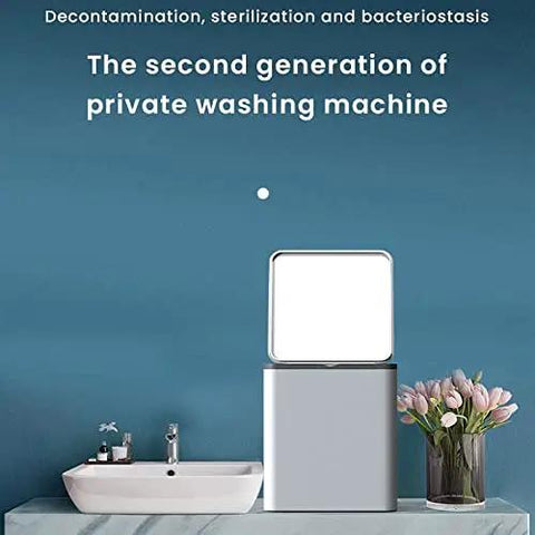 Mini Portable Washing Machine Automatic Compact Laundry Washer Quiet Foldable Frame lightweight design next to a sink with flowers.