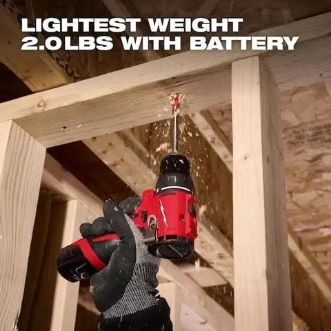 User operating a Compact Brushless Cordless Drill Driver Kit With Heavy Duty Metal Chuck on raw wood framing.