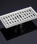 Premium Stainless Steel Rectangular Floor Drain For Bathroom With Massive Flow Deodorant Hair Catcher Slick Shower Grate With Durable Top Tier Light Grey Build viewed on dark surface with visible drainage slot.