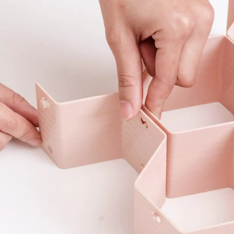 Hands assembling Hella Smooth Honeycomb Drawer Organizer For Closet That Fits Like A Glove And Frees Up Major Space Using Sturdy Abs Plastic Grids.