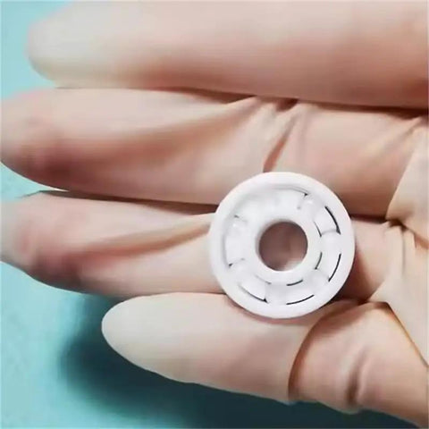 Full Ceramic Bearing ABEC-9 Precision ZrO2 Zirconia Deep Groove Ball Bearing 5x10x4 Millimeters held in a gloved hand.