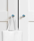 Sweet 1.4 Inch Solid Beechwood Cabinet Knobs And Top Shelf Wooden Drawer Pulls Featuring A Knockout Coastal Sky Design on white cabinet with tote bag.