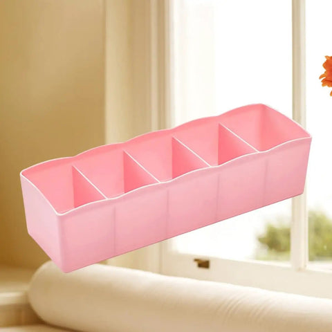 Stackable Plastic Drawer Organizers In Snazzy Pink For Crushing Closet Clutter And Laid Back Home Storage Setup Great For Sock Sorting Underwear Tote Bins And Daily Essentials displayed near a window.