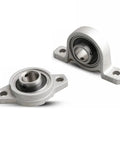 Top Tier Zinc Alloy Pillow Block Ball Bearing With Deep Groove Design And Precision Machined Housing Built Tough For High Performance Operations Runs Like A Dream, showing two bearings with zinc housing.