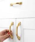 Brushed Gold Cabinet Hardware Three Inch Center To Center Drawer Pulls Ten Pack Heavy Duty Solid Metal kitchen handles on white cabinets.