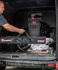 Man loading All-In-One Adjustable Door Hinge Jig Installation Kit For 2 Ft 6 In To 9 Ft Doors into a van, showing the carry case.