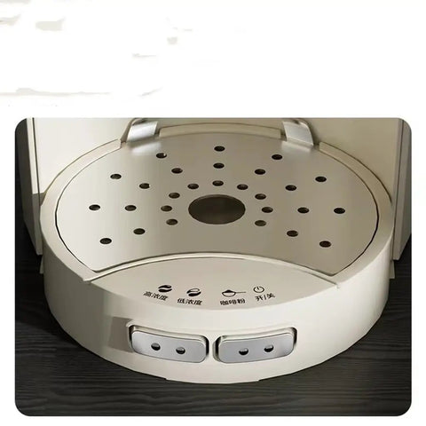Close-up of Automatic Coffee Maker With Built In Grinder And Insulated Travel Cup's drip tray and control buttons.