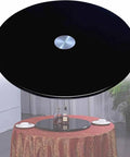 Heavy Duty Black Tempered Glass Lazy Susan Serving Turntable Featuring Smooth As Butter Spin For Effortless Food Sharing And Serious Kitchen Game Changer Vibes In A Generous 31 Inch Format on a table.