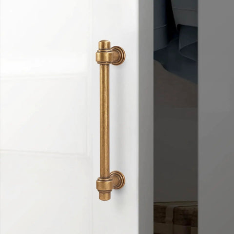 10 Pack 5 Inch Antique Brass Cabinet Pulls Solid Zinc Alloy Drawer Handles on cabinet door for vintage kitchen upgrade.