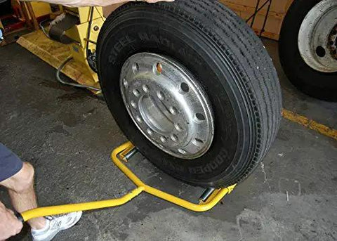 Super Single Truck Wheel Dolly Built With Heavy Gauge Steel And A Low Profile Base For Hauling Massive Otr Trailer Tires Around The Yard Without Breaking A Sweat in use with heavy duty tire.