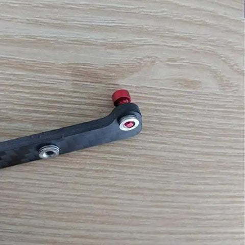 M3 Stainless Steel Clinching Rivet Nuts 30 Pack Rock Hard Press Fasteners for Carbon Fiber Frame Builds attached to a carbon arm.