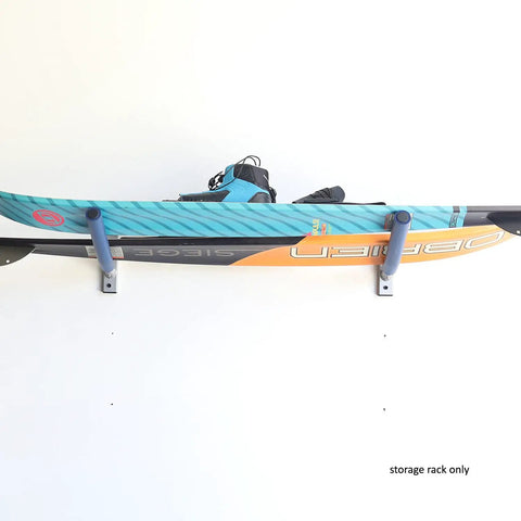 Heavy Duty Single Wall Mount Rack With Gnarly 15 Inch High Density Foam Cradle Arms For SUP Surfboards Water Skis And Skateboards mounted with a wakeboard.