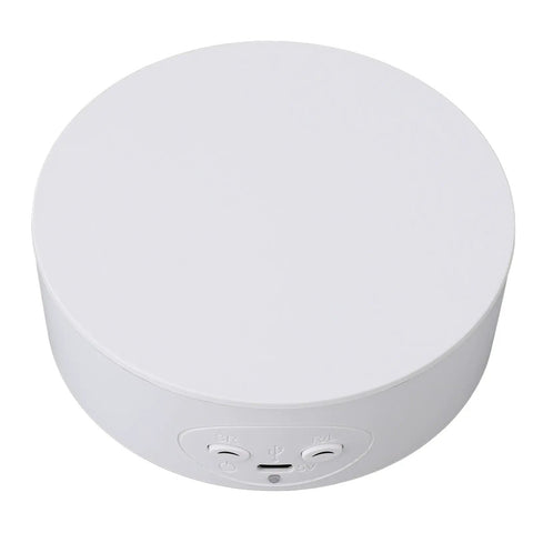 Slick 5 Inch Motorized Rotating Display Stand And Electric Turntable For Jewelry Videos Smooth 360 Degree Auto Rotation With Dual Usb Or Battery Power In Crisp White top view showing power buttons.