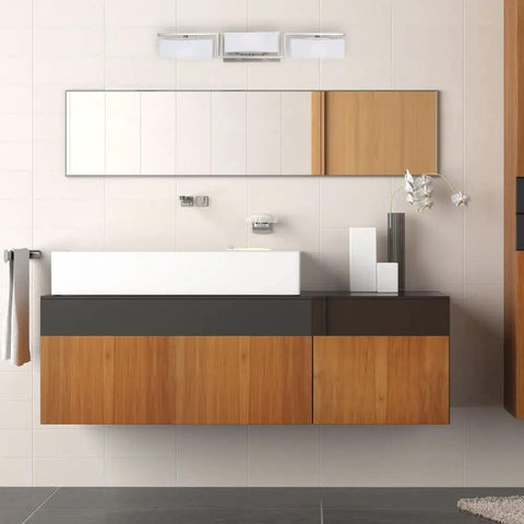Meridian 25 Inch 3 Light Bathroom Vanity Light Fixture in Satin Platinum above modern wooden vanity with mirror.