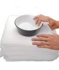 Top Shelf Foam Packing Sheets 100 Pack 12X12 Inch 1/16 Thick Polyethylene Non Abrasive Dust Free Protective Padding For Moving Shipping Storage Heavy Duty Cushioning Boxes And Totes with bowl being wrapped.