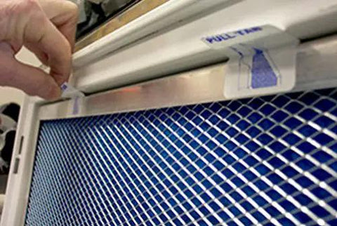 A person installing the Ditch The Cheap Disposables With This Rock Solid Electrostatic Washable Permanent Furnace Air Filter 10x30x1 Reusable Silver Frame.