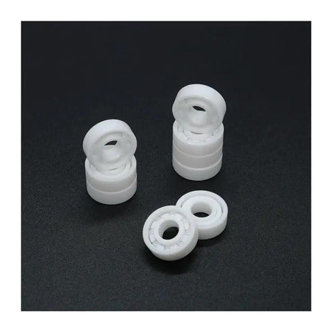 Top Shelf Zirconia Ceramic Ball Bearings Built Solid For Demanding Workshops, white ceramic bearings stacked and displayed.