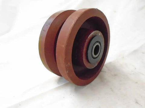 Bulletproof Four Inch Two Inch V Groove Caster Wheel With Seven Eighths Stem Crafted From Rugged Ductile Steel And Rollin Smooth On Heavy Duty Bearings For A Rock Solid One Five Zero Zero Pound Load Rating In Classic Burgundy, showing side view of wheel and bearing.