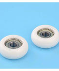 Two 20 Piece Circular Arc Nylon Pulley Rollers with high grade plastic coated bearing on a blue background.