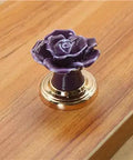 Set Of Ten Vintage Ceramic Rose Cabinet Knobs With Gold Plated Base For Kitchen Drawers And Cupboard Doors. Purple ceramic rose knob on wood.